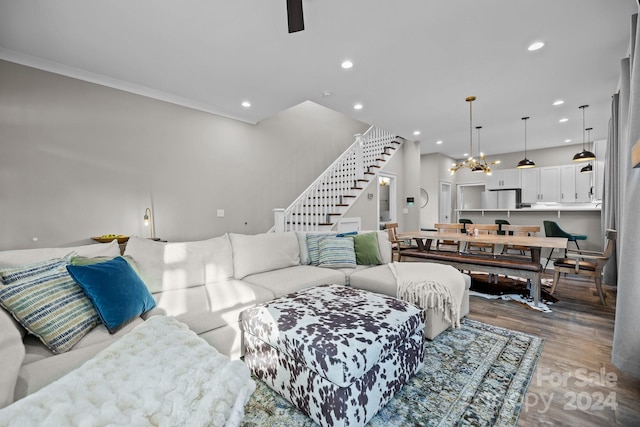 living room with wood-type flooring and ornamental molding