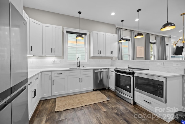 kitchen with plenty of natural light, stainless steel appliances, and hanging light fixtures