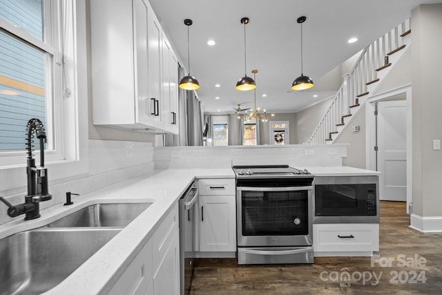 kitchen with decorative backsplash, stainless steel appliances, sink, decorative light fixtures, and white cabinets