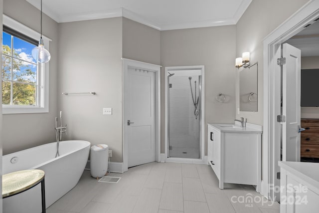 bathroom featuring vanity, ornamental molding, and shower with separate bathtub