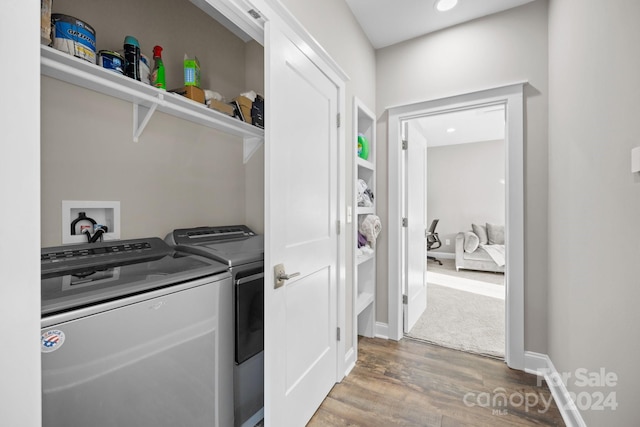 washroom featuring hardwood / wood-style flooring and separate washer and dryer