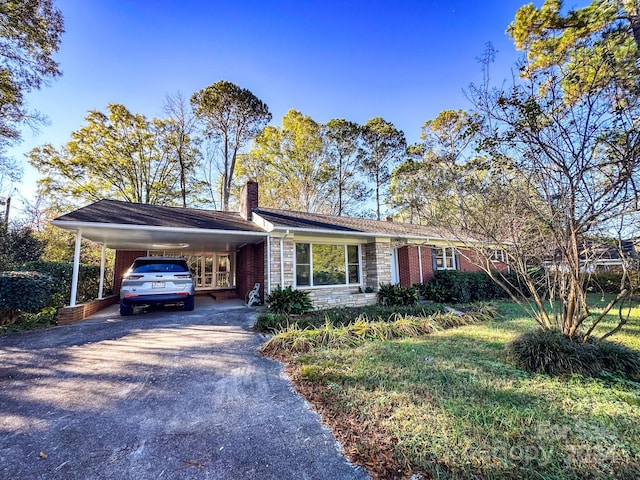 ranch-style home featuring a carport