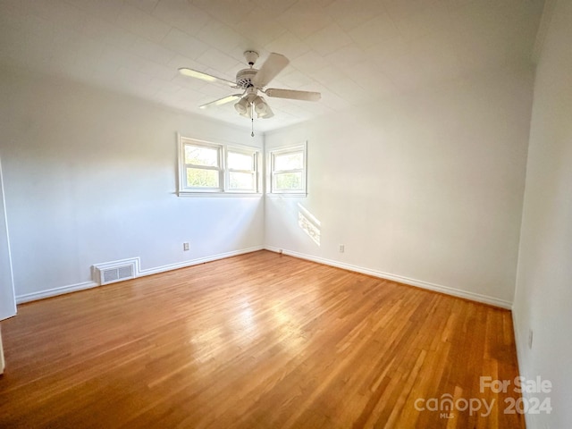 unfurnished room with ceiling fan and wood-type flooring