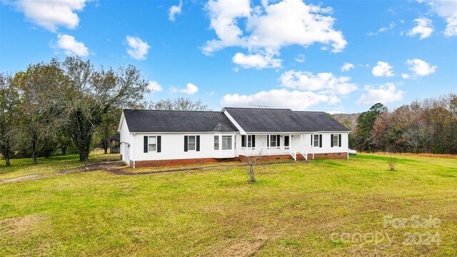 ranch-style home with a porch and a front lawn