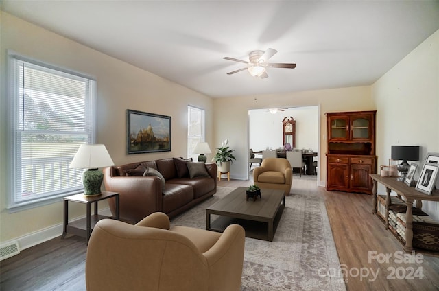 living room featuring ceiling fan and light hardwood / wood-style floors