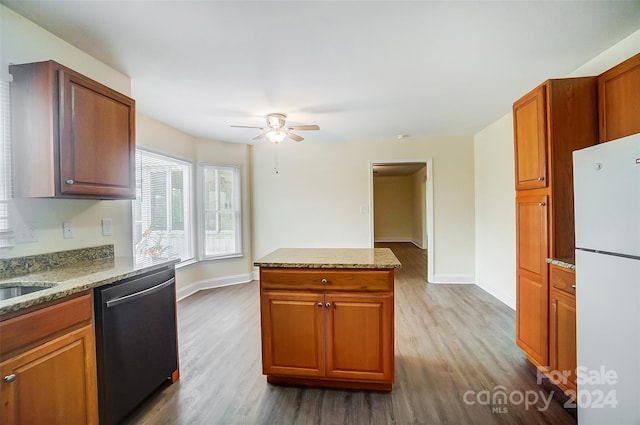 kitchen with stainless steel dishwasher, ceiling fan, white refrigerator, and hardwood / wood-style floors