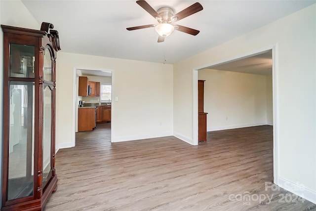 spare room featuring ceiling fan and light hardwood / wood-style floors