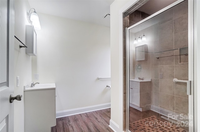 bathroom featuring hardwood / wood-style floors, vanity, and an enclosed shower