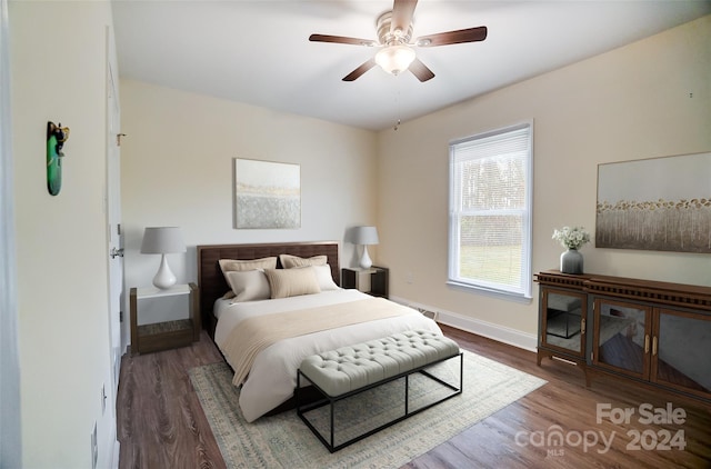 bedroom featuring ceiling fan and dark wood-type flooring