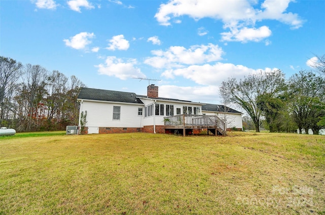 rear view of house with a yard and a wooden deck