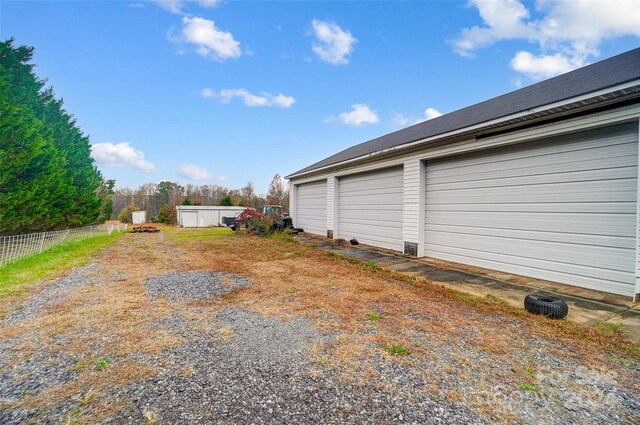 view of yard with a garage and an outdoor structure