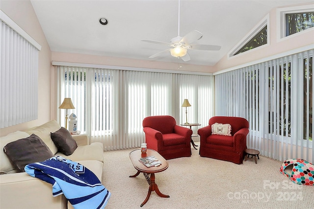 living room with carpet flooring, vaulted ceiling, and ceiling fan