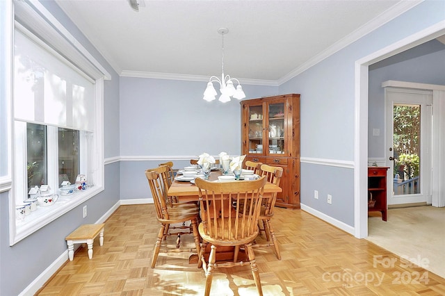 dining room featuring a chandelier, ornamental molding, and light parquet flooring