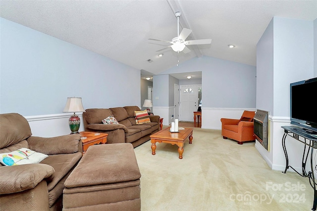 living room featuring a textured ceiling, light colored carpet, ceiling fan, and lofted ceiling