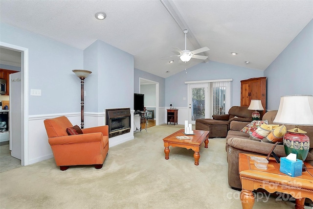 living room featuring french doors, lofted ceiling with beams, ceiling fan, a textured ceiling, and light colored carpet