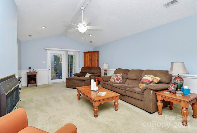 living room with light carpet, vaulted ceiling with beams, ceiling fan, a textured ceiling, and heating unit