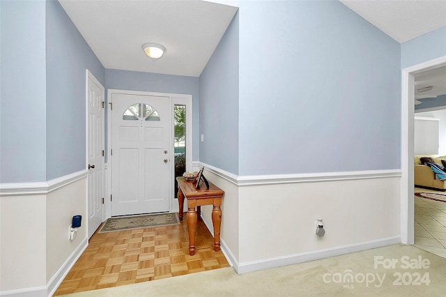 foyer featuring a textured ceiling and parquet flooring