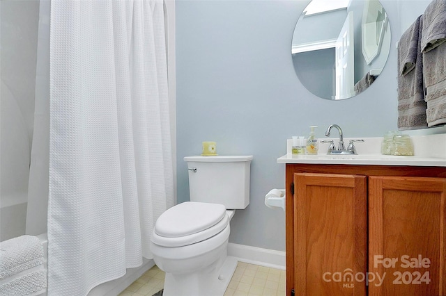 bathroom with vanity, toilet, and curtained shower