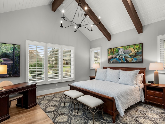 bedroom featuring beam ceiling, multiple windows, light hardwood / wood-style flooring, and a chandelier