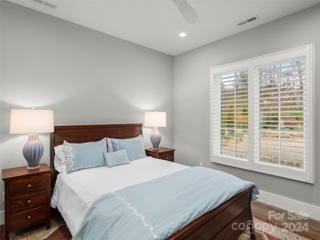 bedroom with ceiling fan and wood-type flooring