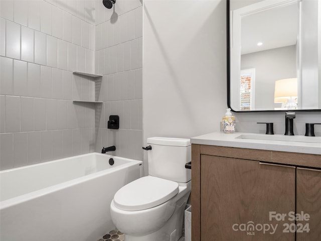 full bathroom featuring vanity, tiled shower / bath combo, and toilet