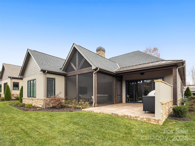 rear view of house featuring a patio and a lawn