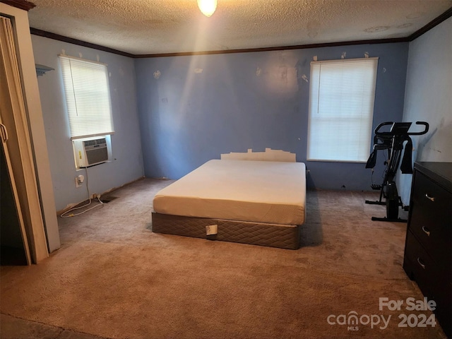 carpeted bedroom with crown molding, cooling unit, and a textured ceiling