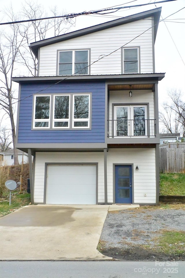 view of front facade with a garage and a balcony