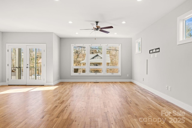 unfurnished living room featuring ceiling fan, light hardwood / wood-style floors, and french doors