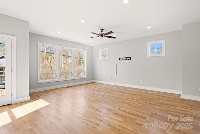 unfurnished living room featuring ceiling fan and light hardwood / wood-style floors