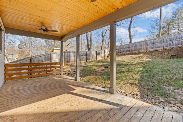 wooden deck with a yard and ceiling fan