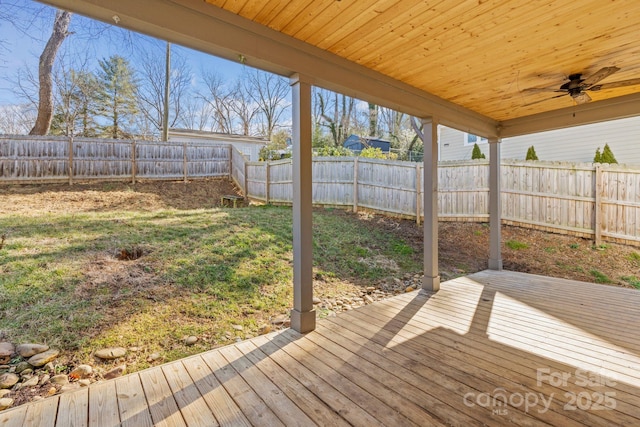 deck with a lawn and ceiling fan