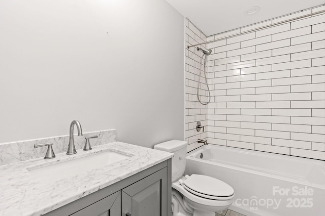 full bathroom featuring vanity, toilet, and tiled shower / bath combo