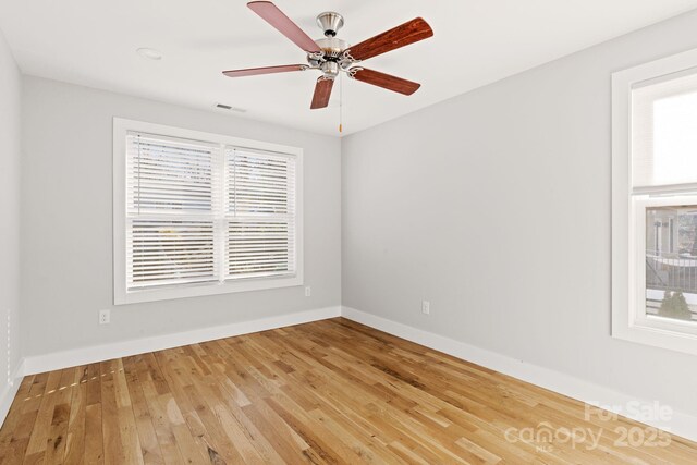 empty room featuring hardwood / wood-style floors and ceiling fan