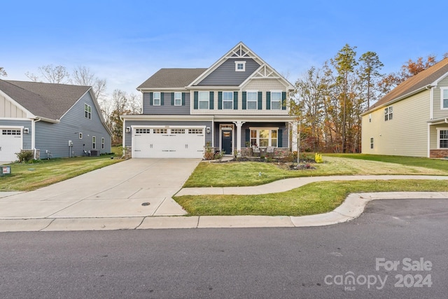 craftsman-style home with a front lawn and a garage