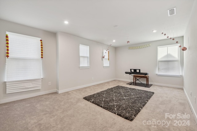 interior space featuring light colored carpet