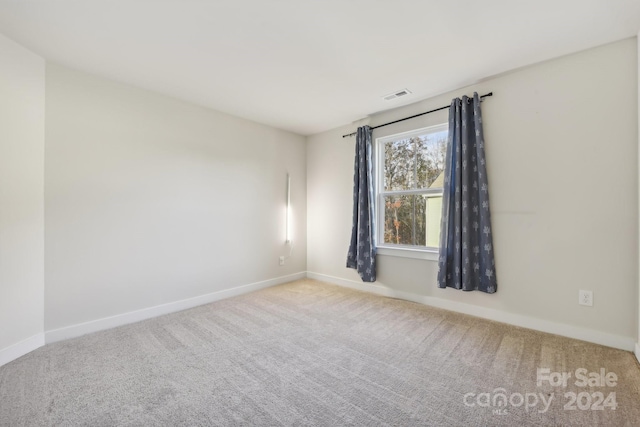 empty room featuring light carpet