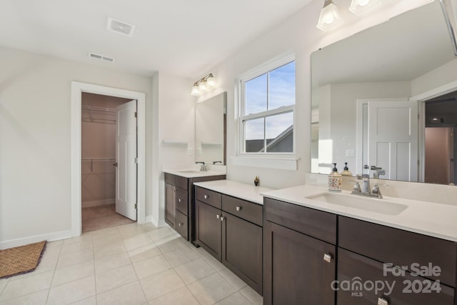 bathroom featuring tile patterned flooring and vanity