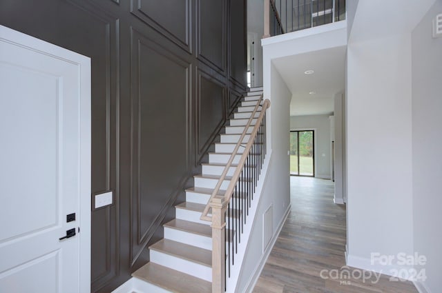 stairway with hardwood / wood-style flooring