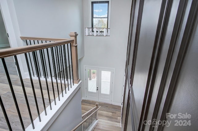 stairway featuring hardwood / wood-style floors and french doors