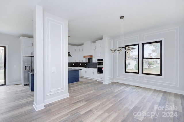 unfurnished living room with light hardwood / wood-style floors