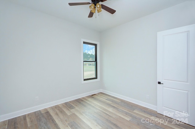 unfurnished room featuring light wood-type flooring and ceiling fan