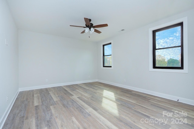 unfurnished room featuring ceiling fan and light hardwood / wood-style floors