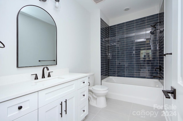 full bathroom featuring tile patterned floors, toilet, vanity, and tiled shower / bath