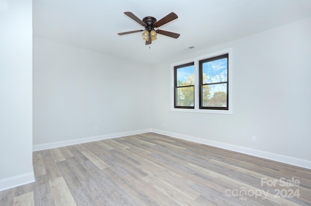 unfurnished room featuring ceiling fan and light hardwood / wood-style flooring