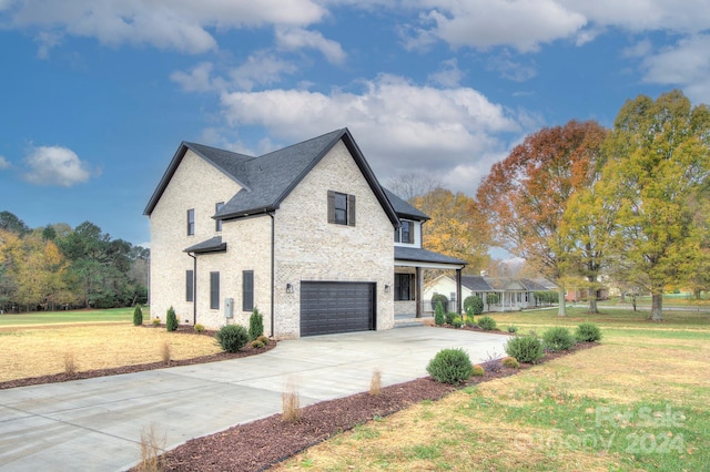 view of home's exterior with a lawn and a garage