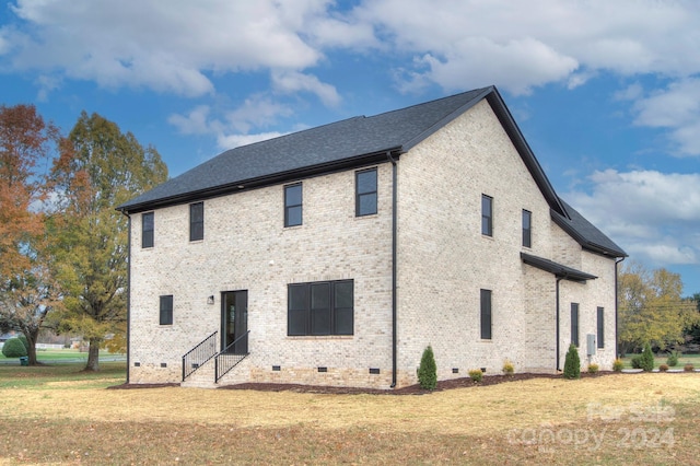 rear view of property with a yard