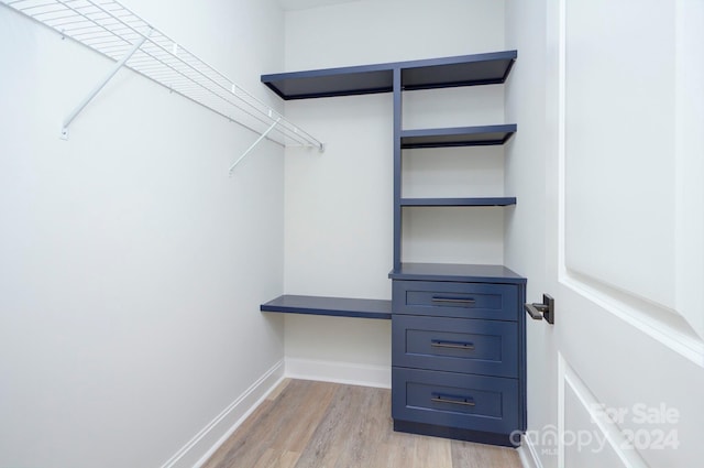 walk in closet featuring light hardwood / wood-style flooring