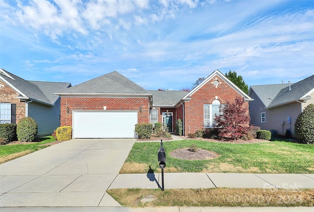 view of front of property with a front yard and a garage