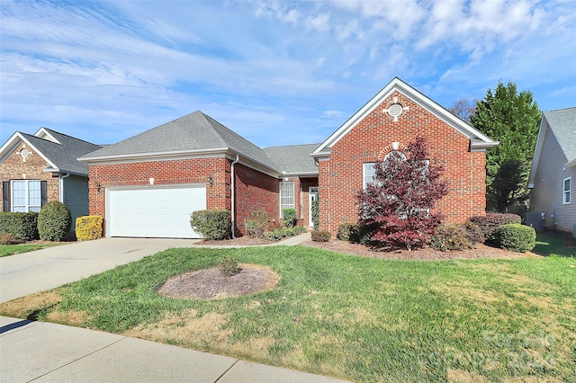 view of front of home with a garage and a front lawn